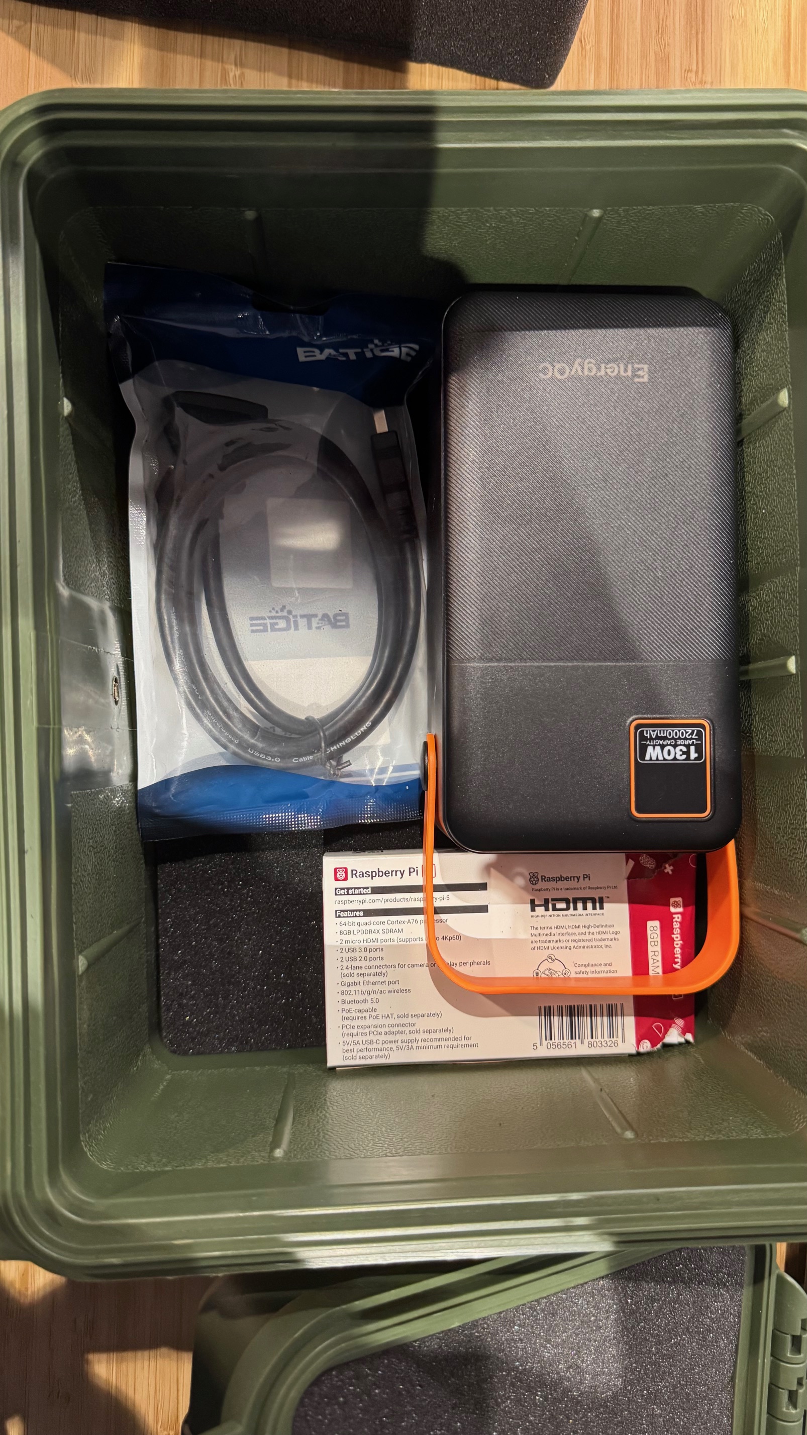 Box of components including power bank and HDMI cable